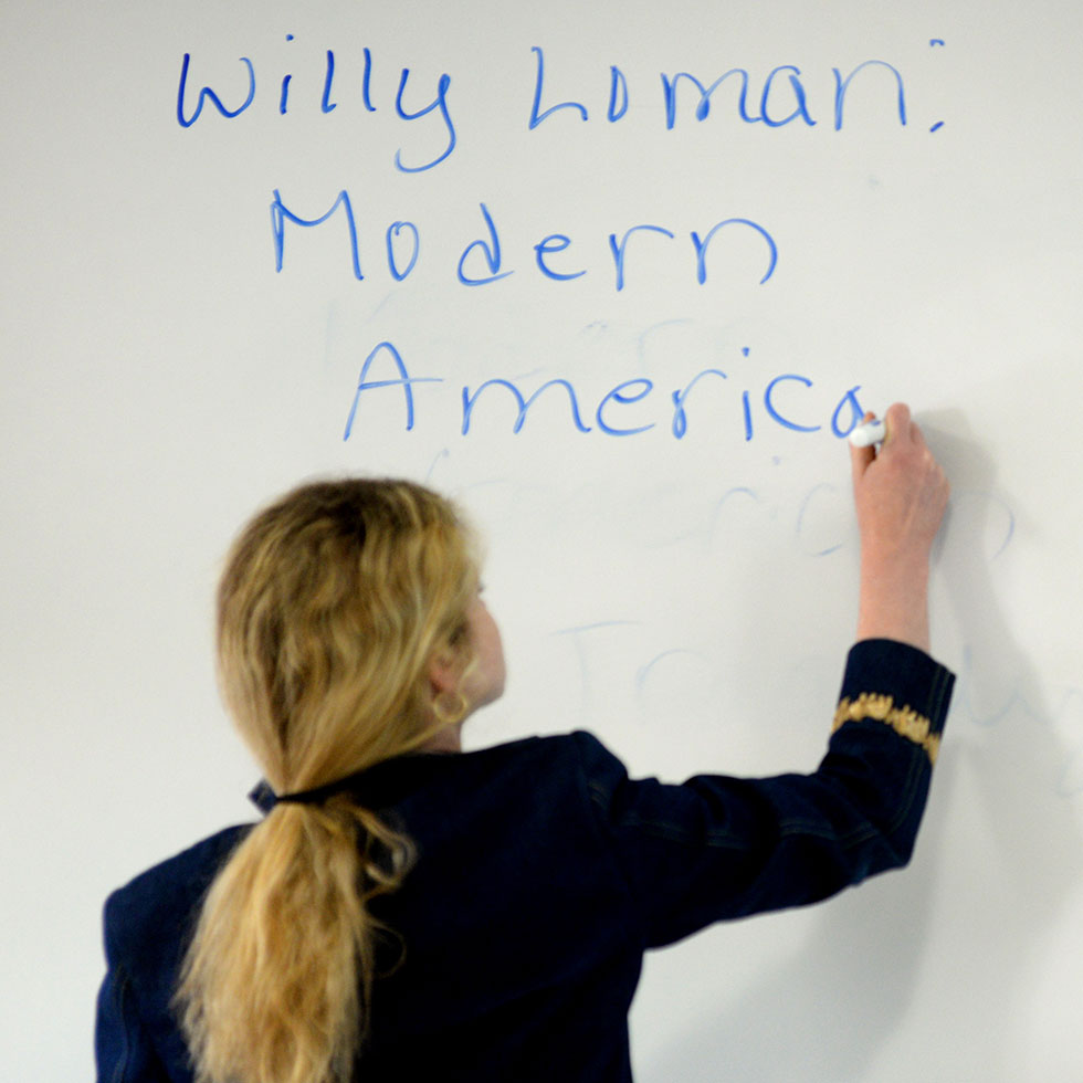 professor writing on the whiteboard 
