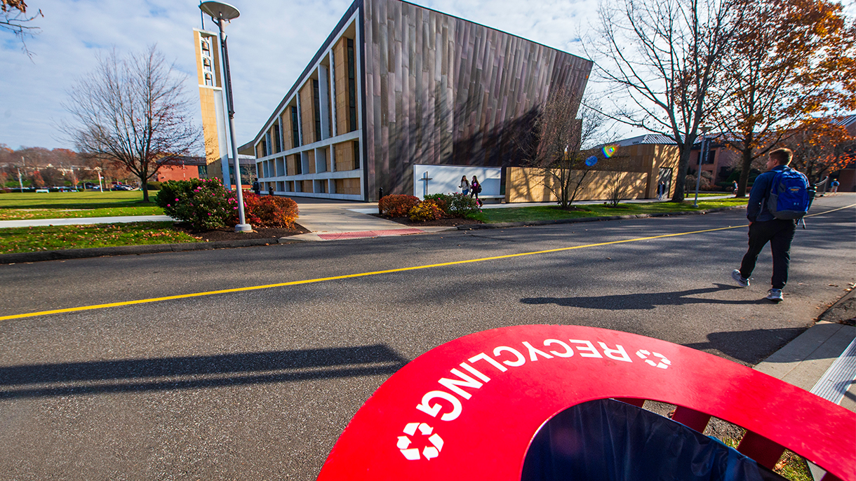 A recycling receptacle in front of the Chapel of the Holy Spirit at Sacred Heart University