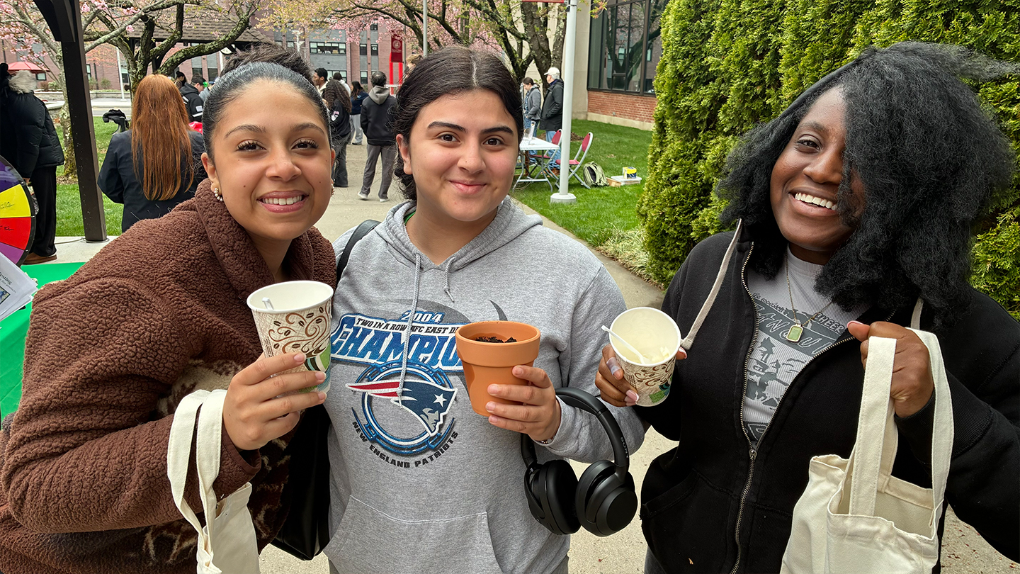 three people holding ice cream, reusable bags and a flower pot
