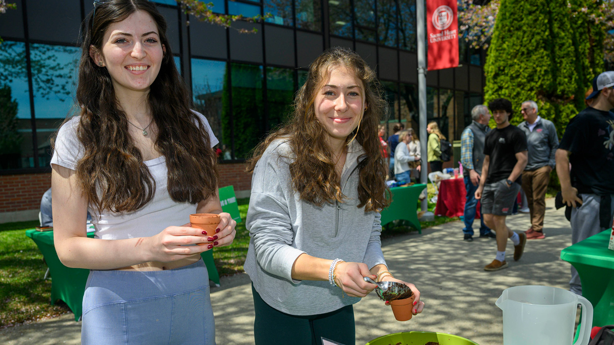 Students filling pots with soil