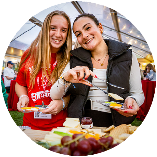 two smiling people getting food