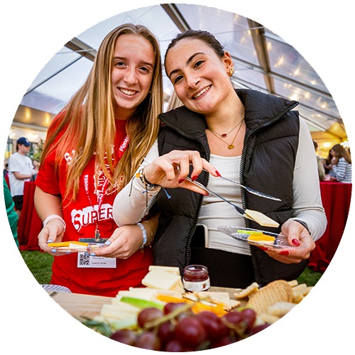 two smiling people getting food