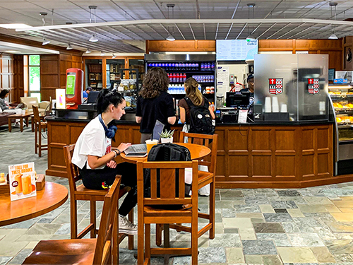 person sitting at a table in a cafe