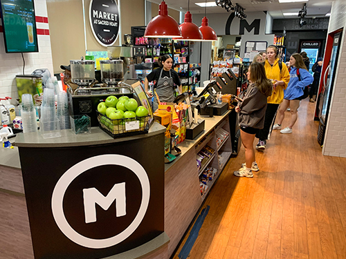 People waiting in line in a college market