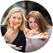 two people eating pizza