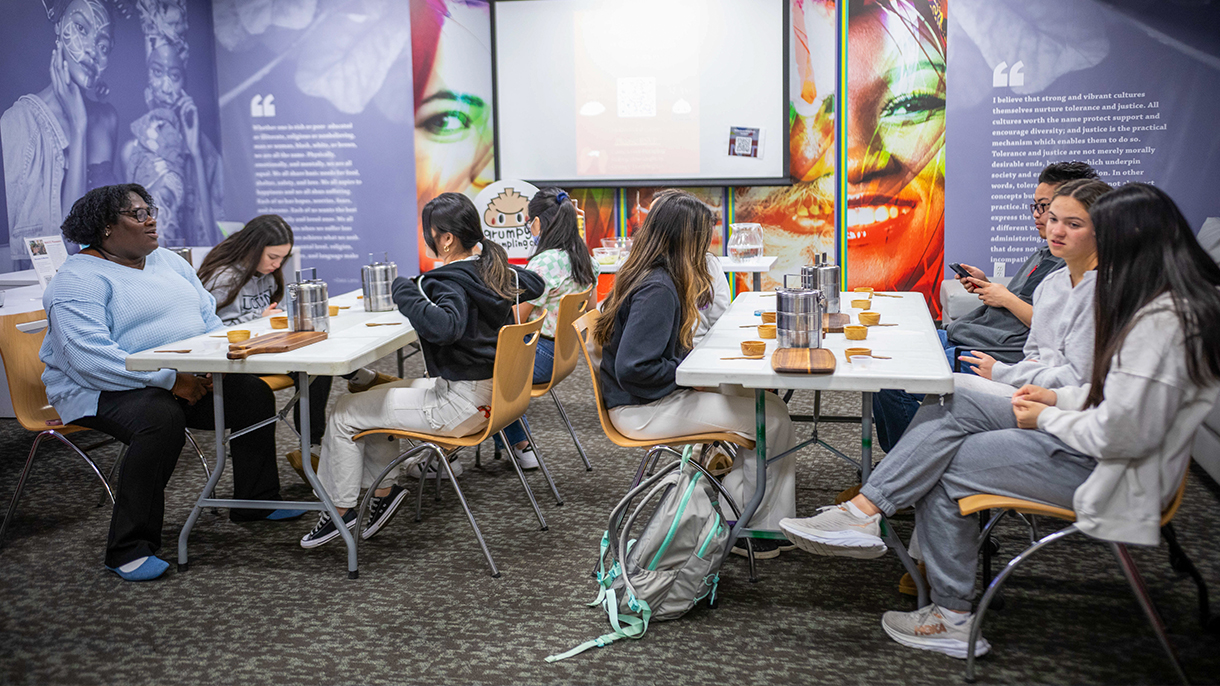 People sitting around tables talking