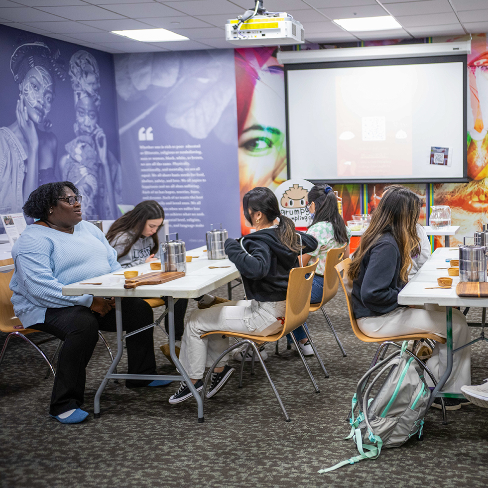 People sitting around tables talking