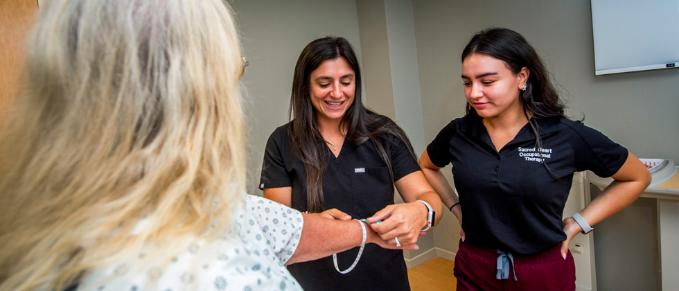 Students checking patients arm