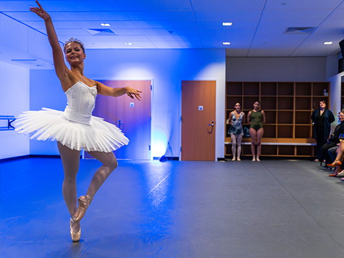 A ballerina performing in a dance studio