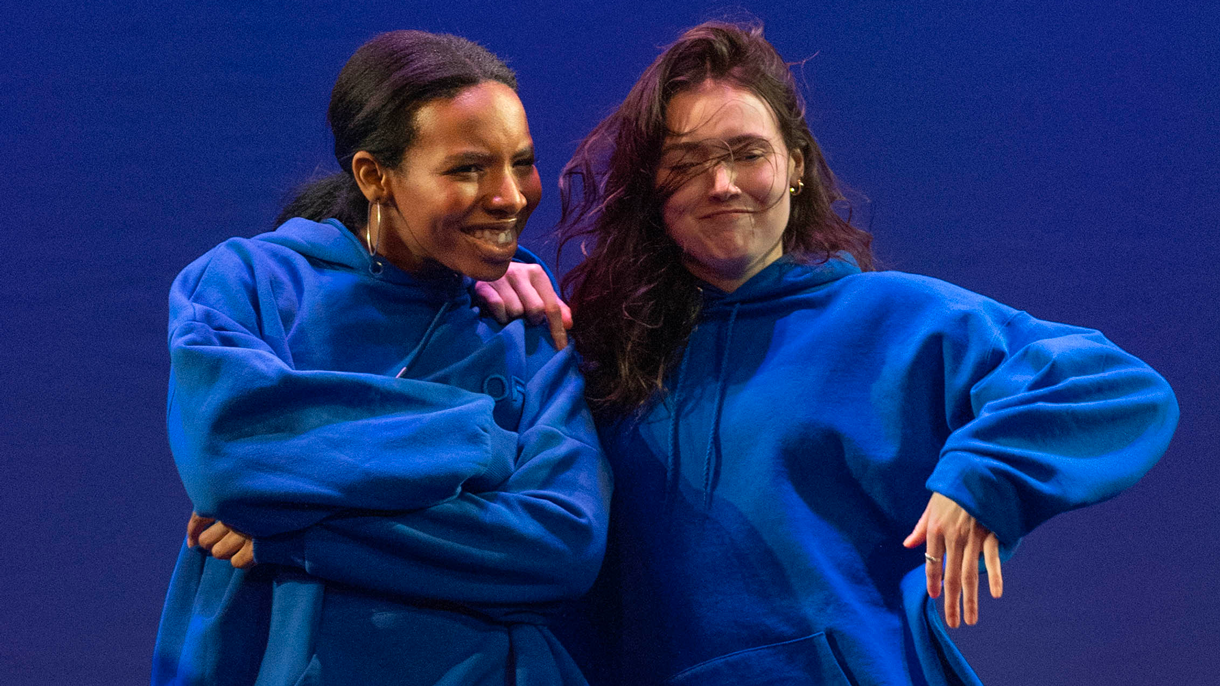 Two dancers leaning on each other