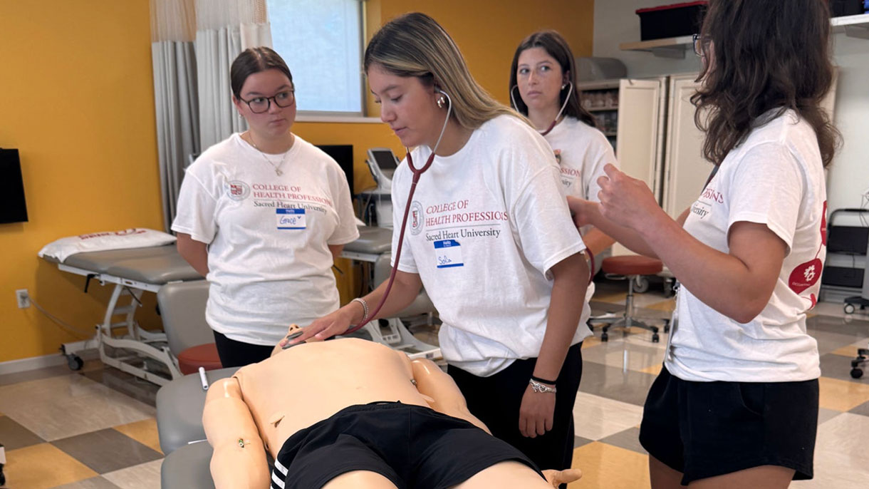 Group of students taking vitals on a manikin