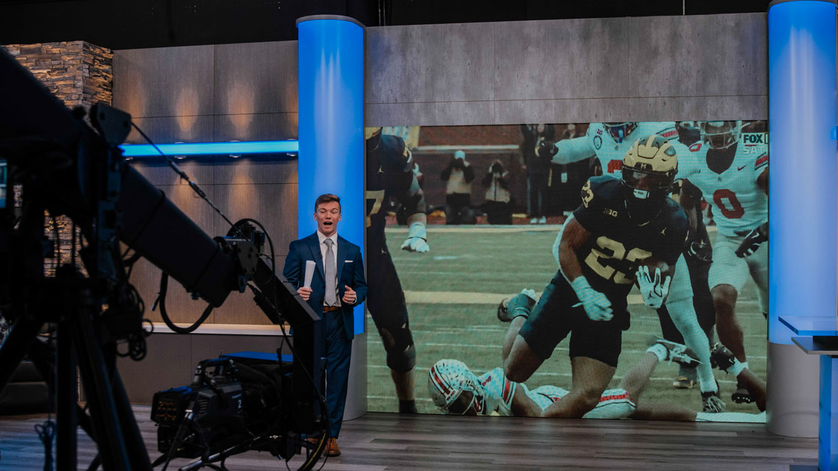 Student reporting on camera in studio