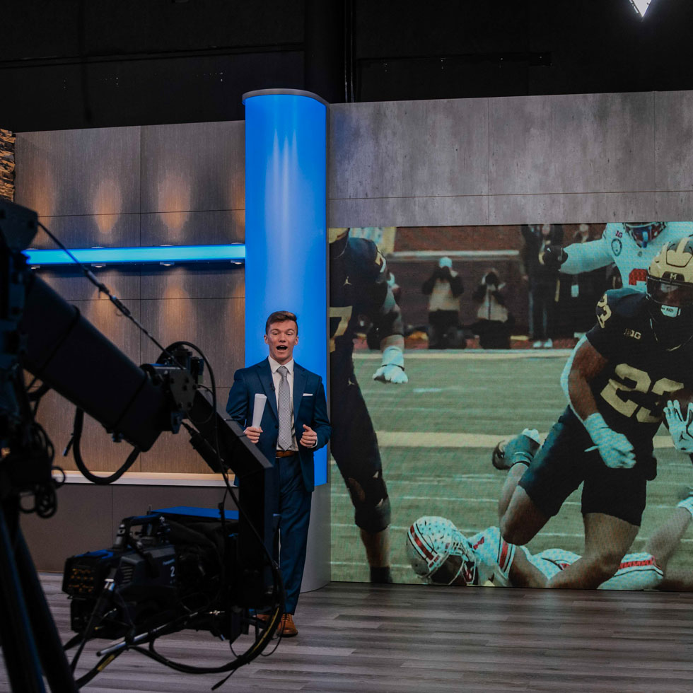 Student reporting on camera in studio