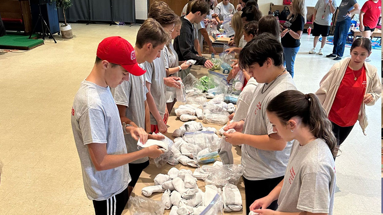 Students packing up supplies for the community