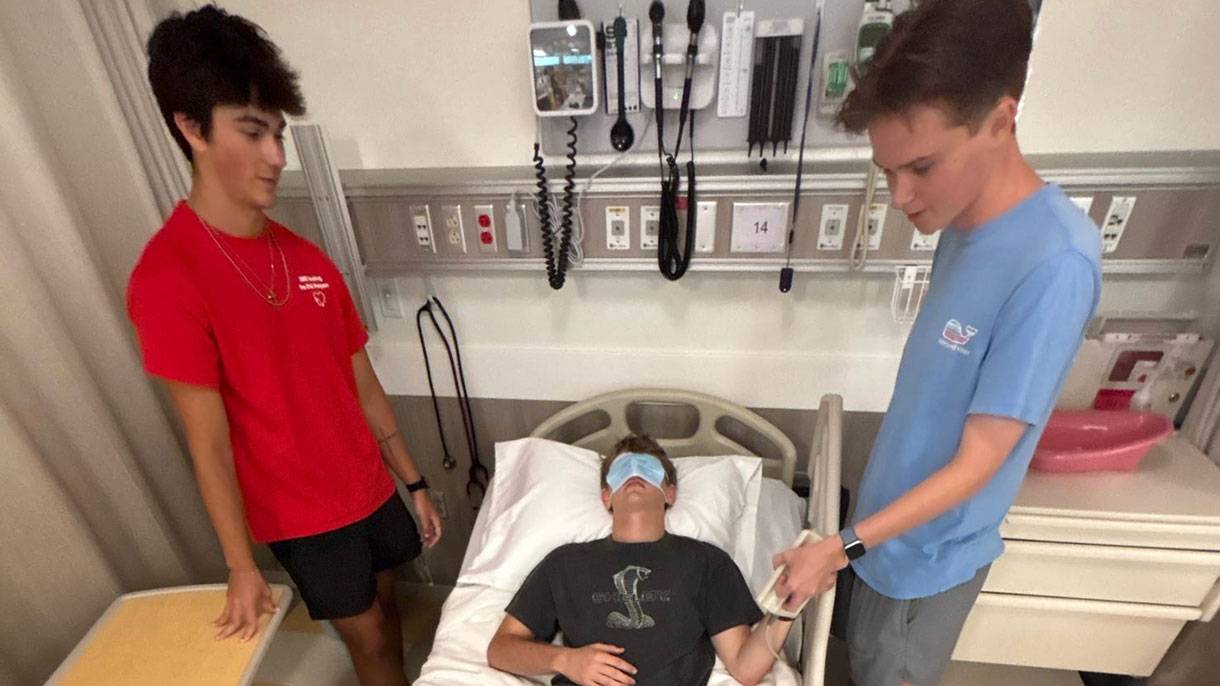 Nursing students tending to a patient