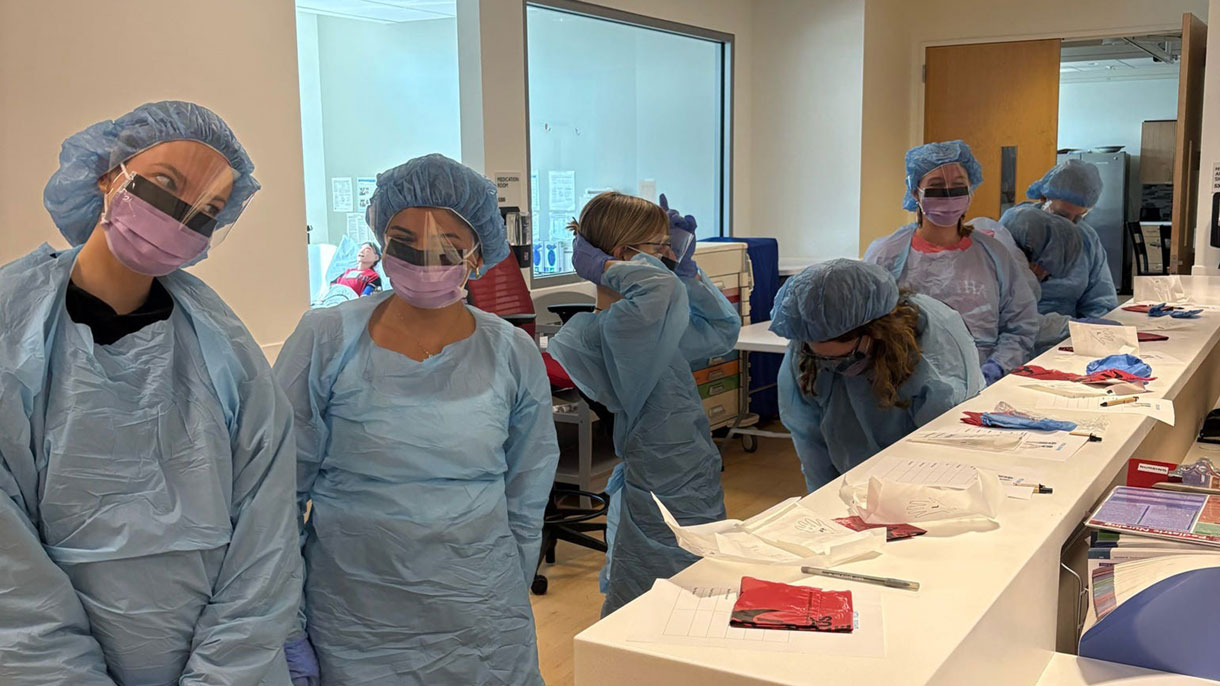 Students in scrubs and protective gear
