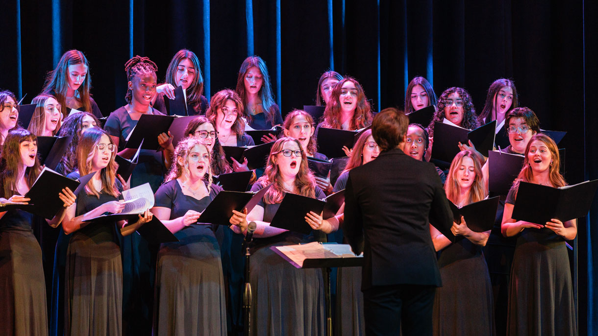 Students singing on stage