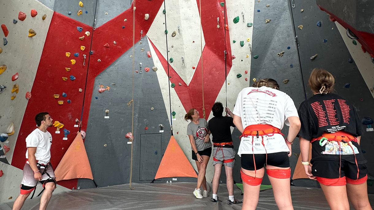 Students using the indoor climbing wall