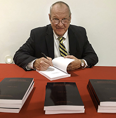 Gary Rose signing a book