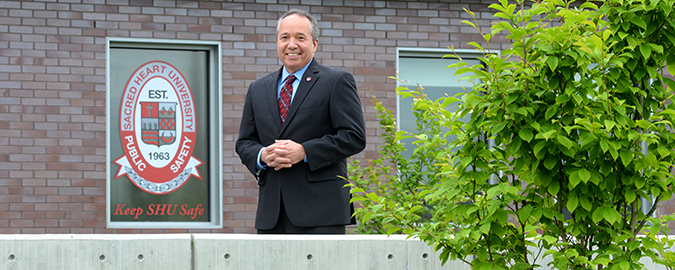Ed Shea smiling for photograph outside Public Safety building