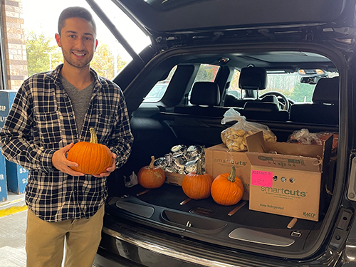 a man standing next to food donations