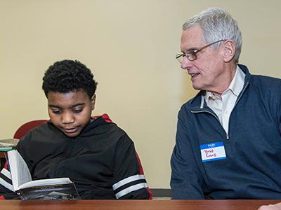 A SHU Horizons student reads to Brad Evans
