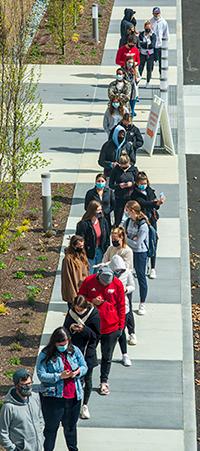college students waiting in line for the COVID vaccination