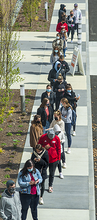 college students waiting in line for the COVID vaccination