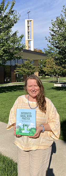 Bronwyn Cross-Denny holding her book