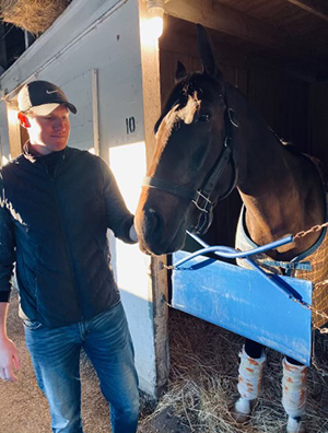 Kinnon LaRose petting a horse