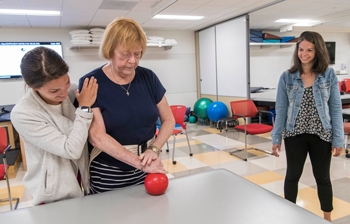 Students helping patient in the Stroke Clinic