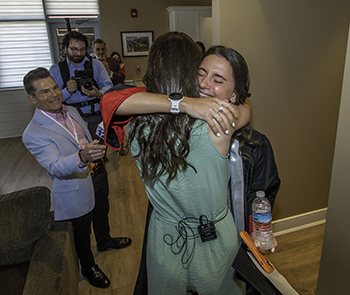 Twins Keegan and Katelyn Pepin hug at a reunion