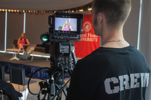 Student filming someone speaking