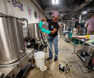Person using pump in brewing factory
