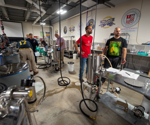 People in brewing lab