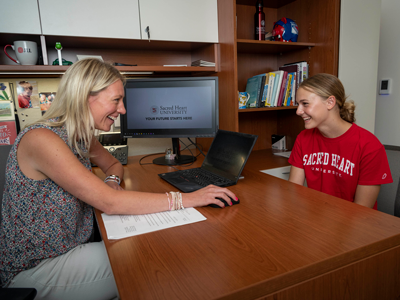 Counselor talking to student in office