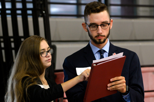 Two students looking at piece of paper