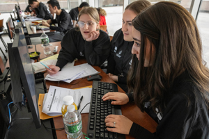 Three girls working together on a computer