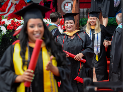 Graduates walking off stage at Commencement