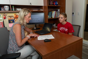 Student talking to counselor in office