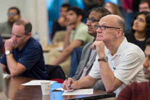 Person in audience listening and taking notes