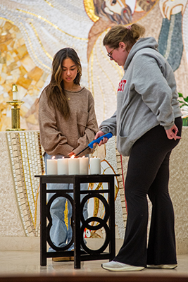 Students lighting candles in Chapel