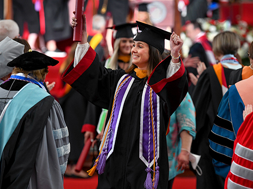 nursing student cheering at commencement ceremony