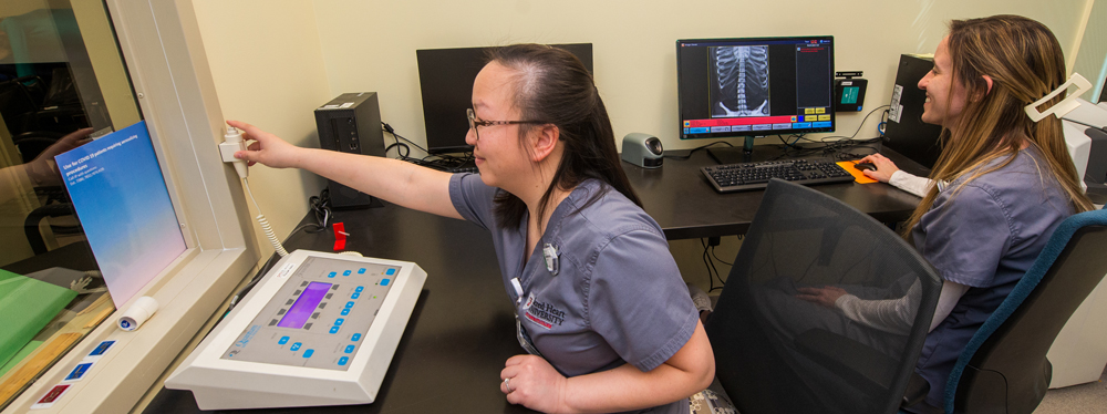 Students using radiography equipment