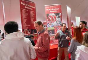 Families talking to coaches at Open House