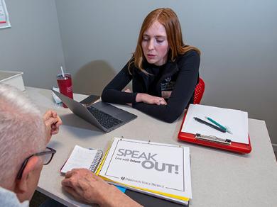 A college speech-language pathology student working with a client