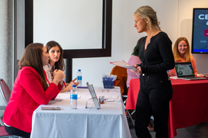 Student talking to women at table during job fair