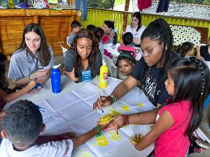 college student do arts and crafts with Colombian children
