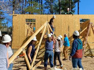 college students working on a Habitat for Humanity house