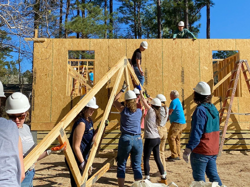 college students working on a Habitat for Humanity house